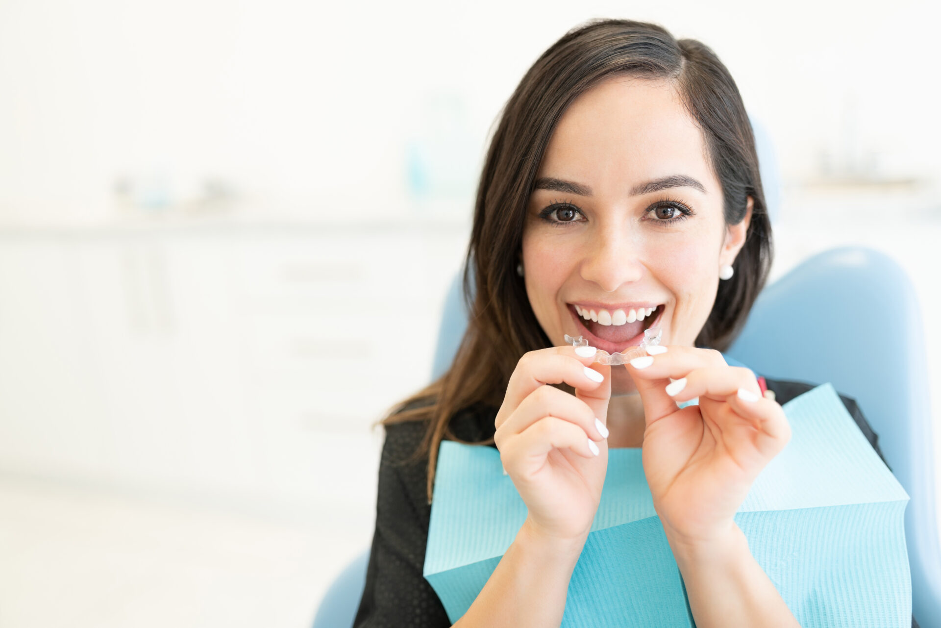 Woman fitting Angel Aligner clear aligners at Cannon Hill Smiles, a discreet Invisalign alternative in Brisbane