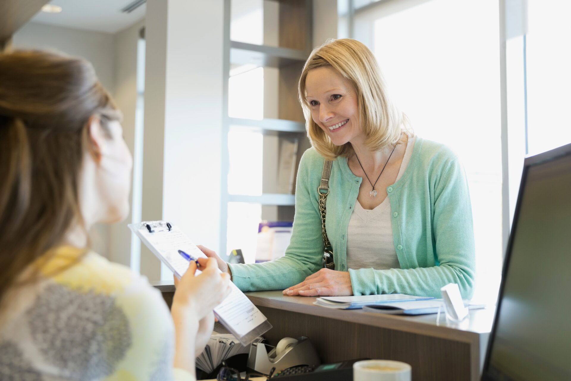 Receptionist Explaining Paperwork To Patient In De 2025 10 15 04 46 47 Utc